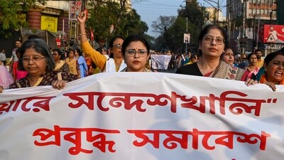 People hold a banner during a protest march against Sandeshkhali case, in Kolkata. (PTI) People hold a banner during a protest march against Sandeshkhali case, in Kolkata. (PTI)