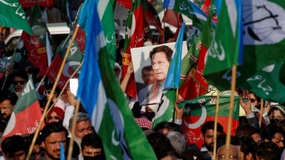 A portrait of the former Prime Minister Imran Khan is seen amid flags of Pakistan Tehreek-e-Insaf (PTI) and the religious and political party Jamat-e-Islami (JI) as supporters attend a joint protest in Karachi on February 10. (Reuters)