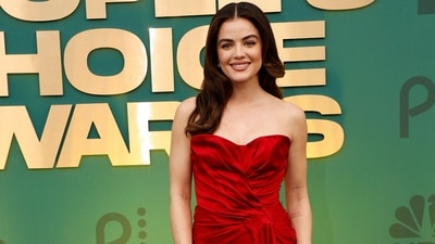 Lucy Hale attended the awards night in a romantic red strapless gown featuring elegant folds. She paired the attire with soft wavy open locks, dainty earrings, caramel lips, subtle eye shadow, mascara on the lashes, on-fleek brows, and blushed glowing skin. (AFP) Lucy Hale attended the awards night in a romantic red strapless gown featuring elegant folds. She paired the attire with soft wavy open locks, dainty earrings, caramel lips, subtle eye shadow, mascara on the lashes, on-fleek brows, and blushed glowing skin. (AFP)