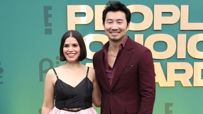 America Ferrera and Simu Liu posed together on the People's Choice Awards red carpet. While America wore a pink and black dress, Simu complemented her in a plum-coloured suit. (Getty Images via AFP) America Ferrera and Simu Liu posed together on the People's Choice Awards red carpet. While America wore a pink and black dress, Simu complemented her in a plum-coloured suit. (Getty Images via AFP)