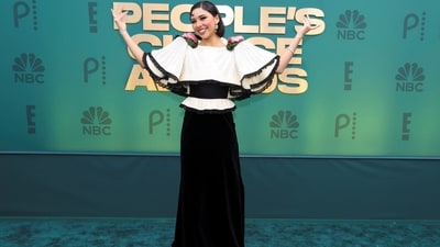 Xochitl Gomez was every bit stunning on the red carpet in a black and white skirt blouse set. While the blouse featured statement sleeves decked with rose adornments, the skirt has a flowy silhouette. She paired the dress with dainty jewellery and a sleek hairdo.&nbsp; (REUTERS)