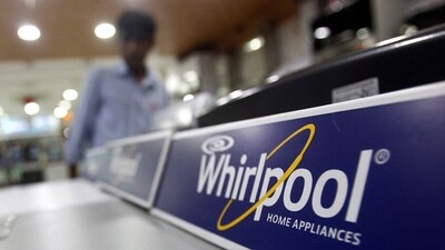 An employee stands next to a Whirlpool washing machine inside a home appliances showroom in New Delhi August 27, 2013.  REUTERS/Anindito Mukherjee (INDIA - Tags: BUSINESS)/File Photo