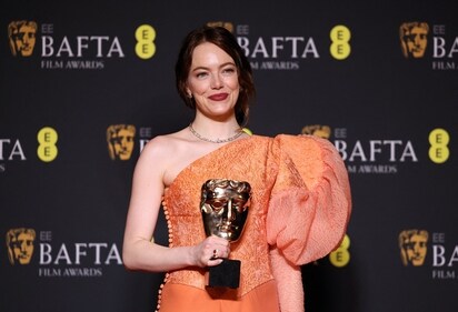 Emma Stone poses in the winners room with her award for Leading Actress for Poor Things. (REUTERS)
