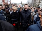 FILE PHOTO: Russian opposition leader Alexei Navalny (2nd R, first row) and his wife Yulia (3rd R, first row) walk during an opposition rally in Moscow, October 27, 2013. REUTERS/Maxim Shemetov/File Photo