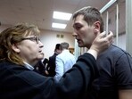 Russian opposition activist and anti-corruption crusader Alexei Navalny's brother Oleg Navalny speaks to his mother Lyudmila, left, at a court in Moscow, Russia, Tuesday, Dec. 30, 2014. 
