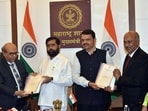 Chairman of the State Backward Classes Commission, retired Justice Sunil Shukre, hands over the survey report on the backwardness of the Maratha community to Maharashtra Chief Minister Eknath Shinde, in Mumbai on Friday. Deputy CM Devendra Fadanvis is also present.