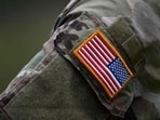 A soldier of the US army wears the country's flag on his uniform. A soldier of the US army wears the country's flag on his uniform.