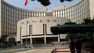 Paramilitary police officers stand guard in front of the headquarters of the People's Bank of China, the central bank (PBOC), in Beijing, China. (Reuters)
