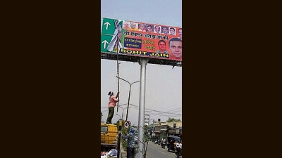 Ludhiana MC workers removing the illegal hoarding from the sign boards on February 20, 2024. (HT Photo)