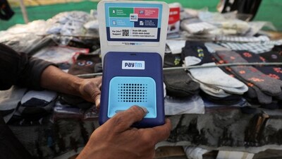Paytm Share Price: Cutlery vendor switches on Paytm, a digital payments firm, speaker to receive received payment details at a roadside market in Ahmedabad.