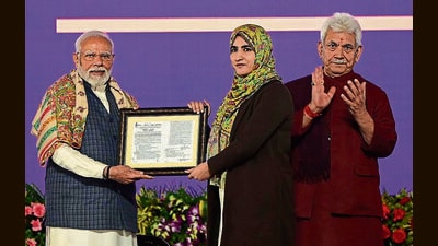 Prime Minister Narendra Modi hands over an appointment letter to new government recruit during a rally at the Maulana Azad Stadium in Jammu on Tuesday. (Waseem Andrabi /HT) Prime Minister Narendra Modi hands over an appointment letter to new government recruit during a rally at the Maulana Azad Stadium in Jammu on Tuesday. (Waseem Andrabi /HT)