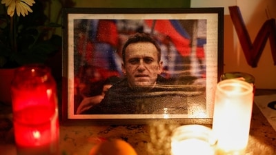 Candles burn as people attend a vigil following the death of Russian opposition leader Alexei Navalny. (Reuters)