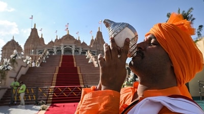 A devotee blows a conch shell (Shankha) during preparations ahead of the arrival of the Indian prime minister for the inauguration of the BAPS Hindu Mandir, the largest Hindu temple in the Middle East, in Abu Dhabi on February 14, 2024. (Photo by RYAN LIM / AFP) (AFP) A devotee blows a conch shell (Shankha) during preparations ahead of the arrival of the Indian prime minister for the inauguration of the BAPS Hindu Mandir, the largest Hindu temple in the Middle East, in Abu Dhabi on February 14, 2024. (Photo by RYAN LIM / AFP) (AFP)