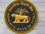 A security official walks past an emblem of the Reserve Bank of India at the RBI headquarters, in Mumbai. A security official walks past an emblem of the Reserve Bank of India at the RBI headquarters, in Mumbai.