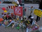 A person views a memorial dedicated to the victims of last week's mass shooting in front of Union Station, Sunday, Feb. 18, 2024, in Kansas City, Mo (AP Photo/Charlie Riedel, File)