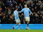 Manchester City's Erling Braut Haaland celebrates scoring their first goal with Phil Foden