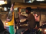 Bengaluru: Man riding the auto with the dog in his lap. Bengaluru: Man riding the auto with the dog in his lap.