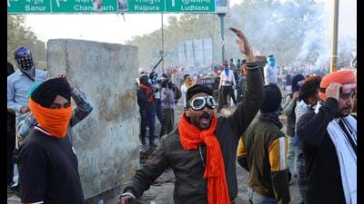 A man gestures, as farmers march towards New Delhi to press for better crop prices promised to them in 2021, next to Shambhu barrier, a border crossing between Punjab and Haryana states. (REUTERS)