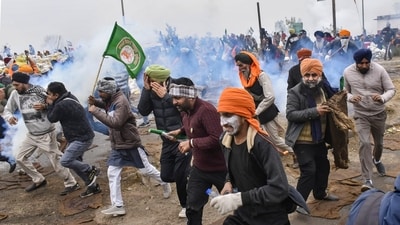 Protesting farmers disperse after a tear gas firing during their 'Delhi Chalo' march, at Shambhu Border. (PTI) Protesting farmers disperse after a tear gas firing during their 'Delhi Chalo' march, at Shambhu Border. (PTI)