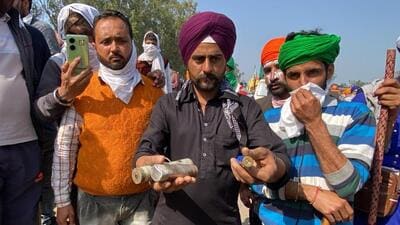 Protesting farmers holding tear gas shells at Khanauri on the Haryana-Punjab interstate border. (HT Photo)