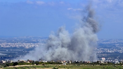 Smoke billows from the site of an Israeli airstrike on the villages of Mansouri and Majdelzoun near Lebanon's southern border. (AFP)