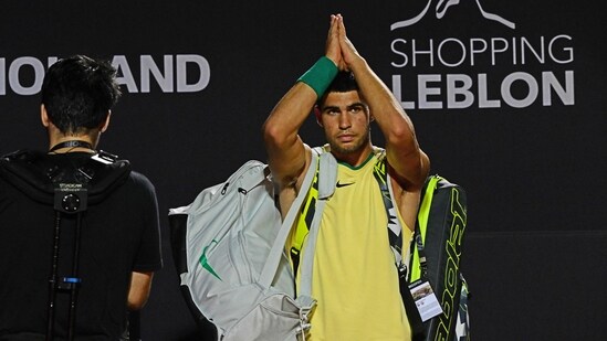 Spain's Carlos Alcaraz greets the public after abandoning the ATP 500 Rio Open tennis match against Brazil's Carlos Monteiro due to an injury, (AFP)