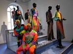 From left, designers Glen and Bruce Proctor pose for portraits in front of their creations at the fashion hub part of the women's Fall-Winter 2024-25 collection presented in Milan, northern Italy.