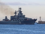 The Russian Navy's guided missile cruiser Moskva sails back into a harbour after tracking NATO warships in the Black Sea.