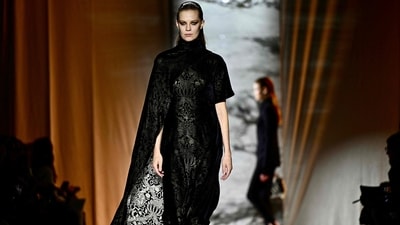 Roberto Cavalli's Autumn/Winter collection showcased gothic chic vibes with bold colours and exquisite designs. One of the models wore an all-black ensemble featuring a high neckline, body-hugging fit, intricate gold embroidery all over and a long cape attached to the side. (AFP) Roberto Cavalli's Autumn/Winter collection showcased gothic chic vibes with bold colours and exquisite designs. One of the models wore an all-black ensemble featuring a high neckline, body-hugging fit, intricate gold embroidery all over and a long cape attached to the side. (AFP)