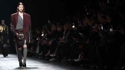 Oversized chic dominated the Etro collection show at Milan Fashion Week. One of the models wore a grey oversized top with an off-the-shoulder neckline, teamed with a chic mini skirt adorned with mesmerising black shiny detailing. Paired with a matching oversized blazer, the look defines trendiness. (AFP) Oversized chic dominated the Etro collection show at Milan Fashion Week. One of the models wore a grey oversized top with an off-the-shoulder neckline, teamed with a chic mini skirt adorned with mesmerising black shiny detailing. Paired with a matching oversized blazer, the look defines trendiness. (AFP)