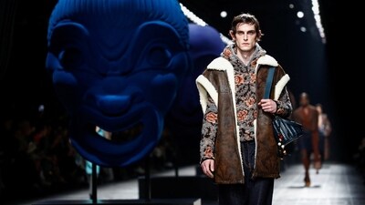 Flowers and leather were all over Etro's Autumn/Winter 2024/2025 collection during Milan Fashion Week. The model wore a chic black hoodie with a trendy print in shades of orange and grey. Paired with a stunning brown jacket and blue trousers, the look was sure to set fashion trends. (REUTERS/Alessandro Garofalo)