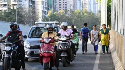 Mumbai, India. Feb 22,2024 - Pedestrians walked on Delisle Bride in Parel, after 5 year Delisle bridge fully opened up to motorists. People complain that there is no footpath for pedestrians.Feb 22,2024. (Photo by Raju Shinde/HT Photo) Mumbai, India. Feb 22,2024 - Pedestrians walked on Delisle Bride in Parel, after 5 year Delisle bridge fully opened up to motorists. People complain that there is no footpath for pedestrians.Feb 22,2024. (Photo by Raju Shinde/HT Photo)