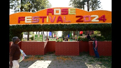 Workers installing the “Rose Festival 2024” welcome board at the front gate of Rose Garden in Chandigarh on Wednesday. (Ravi Kumar/HT)
