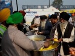 Volunteers serve food which was prepared at the Gurdwara Dukh Nivaran Sahib to farmers at the site of a protest where farmers are demanding better crop prices promised to them in 2021, at Shambhu Barrier, a border crossing between Punjab and Haryana states, India, February 20, 2024. 