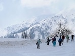 People walk through the snow in Gulmarg, J&K. People walk through the snow in Gulmarg, J&K.