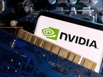A smartphone with a displayed NVIDIA logo is placed on a computer motherboard.