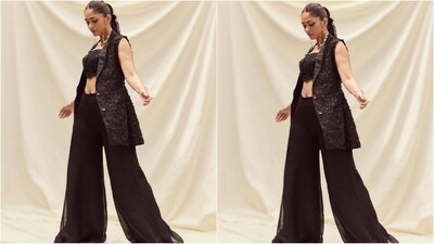 Mrunal's outfit comes in an alluring shade of black and features a luxurious georgette fabric and crop top embellished with intricate sequin embroidery. She teamed it with a matching half-sleeved blazer with satin lining and a button-fastening bodice. With black flared palazzo pants, she rocked the outfit. (Instagram/@mrunalthakur) Mrunal's outfit comes in an alluring shade of black and features a luxurious georgette fabric and crop top embellished with intricate sequin embroidery. She teamed it with a matching half-sleeved blazer with satin lining and a button-fastening bodice. With black flared palazzo pants, she rocked the outfit. (Instagram/@mrunalthakur)