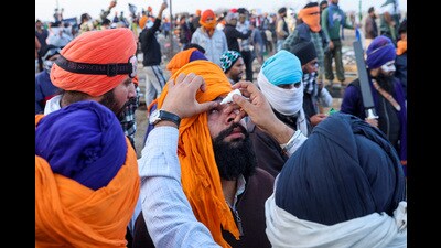A paramedic puts drops in eyes of a farmer after tear gas at Shambhu border. (REUTERS) A paramedic puts drops in eyes of a farmer after tear gas at Shambhu border. (REUTERS)