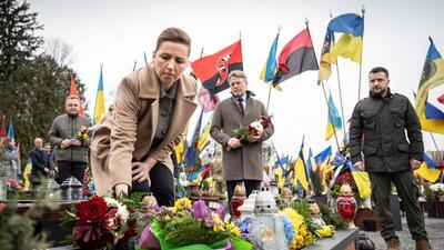 Denmark's Prime Minister Mette Frederiksen (C), her husband Bo Tengberg (C) and Ukraine's President Volodymyr Zelensky (R) arrive to lay flowers during a memorial ceremony at the Field of Mars of Lychakiv Cemetery, in Lviv, on February 23, 2024. (AFP) Denmark's Prime Minister Mette Frederiksen (C), her husband Bo Tengberg (C) and Ukraine's President Volodymyr Zelensky (R) arrive to lay flowers during a memorial ceremony at the Field of Mars of Lychakiv Cemetery, in Lviv, on February 23, 2024. (AFP)