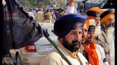 Farmers tying a black cloth on their turbans to mark Black Day protest against the Union government and Haryana government during their ongoing 'Delhi Chalo' march, at Shambhu Border in Patiala on Friday. (ANI)