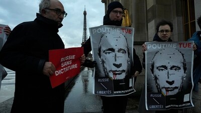 Demonstrators hold poster during a gathering in homage to late Russian opposition leader Alexei Navalny, at the Trocadero square on Thursday in Paris. (AP) Demonstrators hold poster during a gathering in homage to late Russian opposition leader Alexei Navalny, at the Trocadero square on Thursday in Paris. (AP)