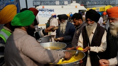 Volunteers serve food which was prepared at the Gurdwara Dukh Nivaran Sahib to farmers at the site of a protest where farmers are demanding better crop prices promised to them in 2021, at Shambhu Barrier, a border crossing between Punjab and Haryana states, India, February 20, 2024. (REUTERS)