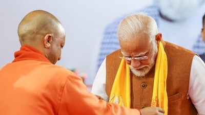 PM Modi in Varanasi: Yogi Adityanath sharing stage with the prime minister. (PTI) PM Modi in Varanasi: Yogi Adityanath sharing stage with the prime minister. (PTI)