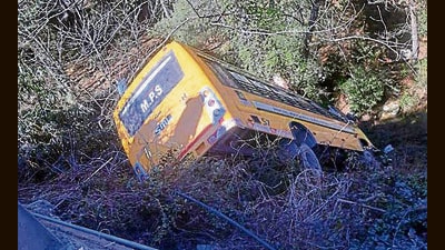 The school bus hit a parked car before veering off road in Banjar area of Kullu district on Friday. (Aqil Khan/HT)