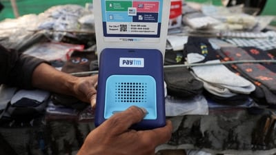 Paytm crisis: Cutlery vendor switches on Paytm, a digital payments firm, speaker to receive received payment details at a roadside market in Ahmedabad. (Reuters)