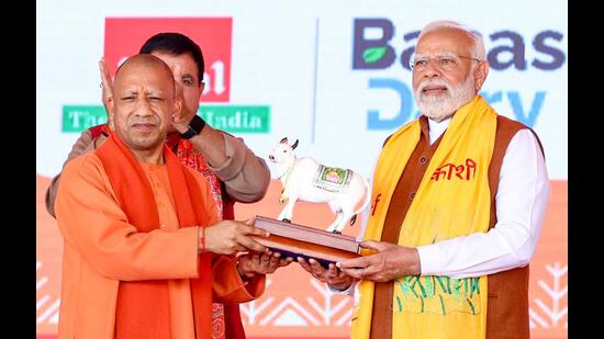 Prime Minister Narendra Modi being felicitated by Uttar Pradesh chief minister Yogi Adityanath at the inauguration and foundation ceremony of several development projects, in Varanasi on Friday. (ANI Photo)
