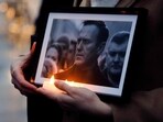 A protester holds candles and a picture of the late opposition leader Alexei Navalny during a demonstration in Paris on February 22. A protester holds candles and a picture of the late opposition leader Alexei Navalny during a demonstration in Paris on February 22.