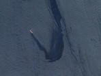 In this satellite image provided by Planet Labs, the Belize-flagged bulk carrier Rubymar is seen in the southern Red Sea near the Bay el-Mandeb Strait leaking oil after an attack by Yemen's Houthi rebels Feb. 20, 2024.