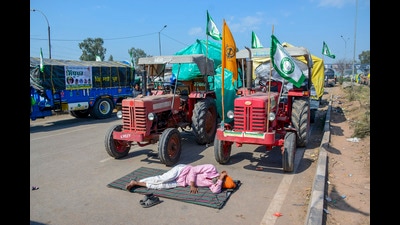 A farmer rests during farmers 'Delhi Chalo' march, near the Punjab-Haryana Shambhu border, in Patiala district, on Saturday. (PTI)