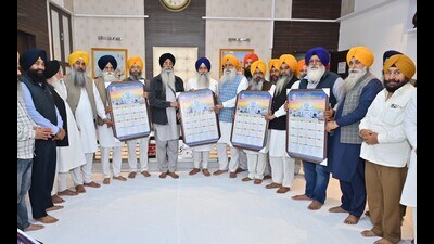 Akal Takht jathedar Raghbir Singh along with Shiromani Gurdwara Parbandhak Committee (SGPC) president Harjinder Singh Dhami release the Nanakshahi calendar in Amritsar on Saturday. (HT photo)